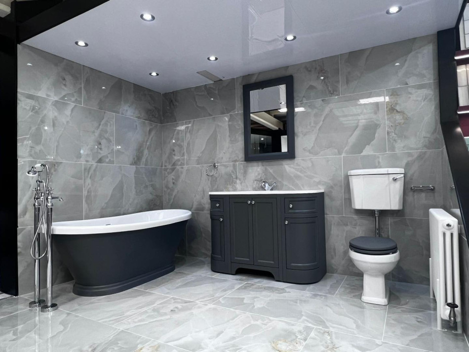 Standalone bath with dark grey furniture