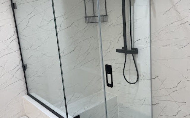Shower with built in seat and modern black detail and trim