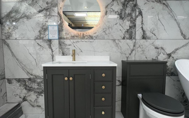 Contemporary style bathroom with modern grey units with marble tiles