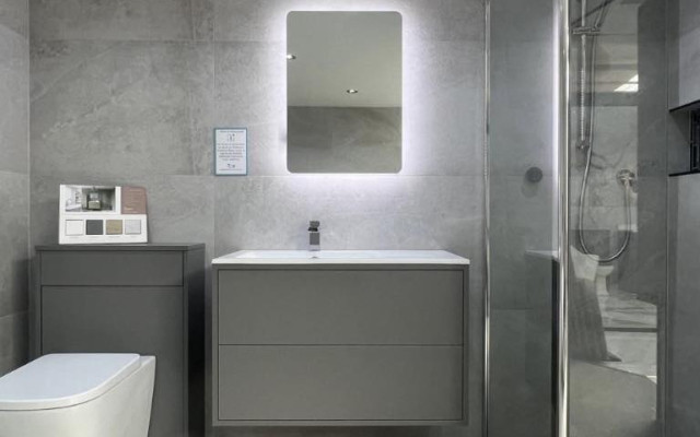 Compact bathroom shower enclosure and floating vanity unit