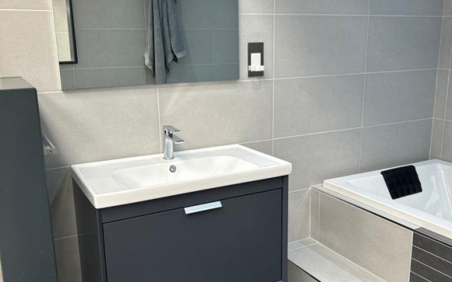 Floating vanity unit with step to bath